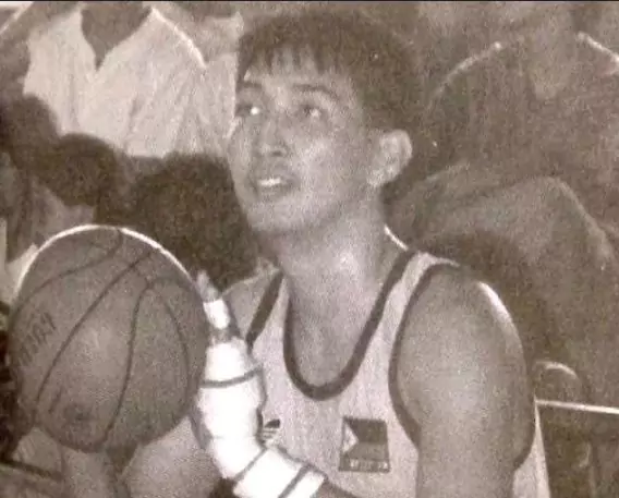 a man taking three point shot in basketball game
